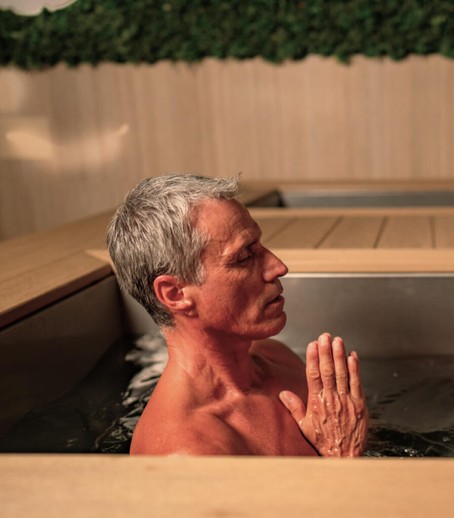 A man sitting outside while doing Cold Water Therapy.